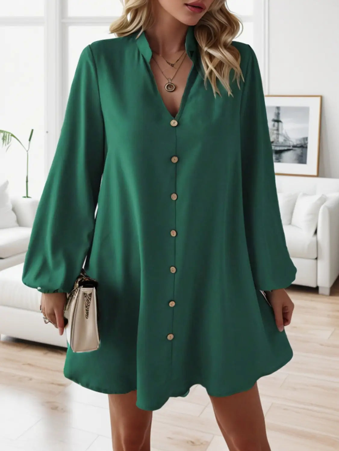 Emerald green bell sleeve button down midi dress featuring long sleeves v-neckline and a flared hem.