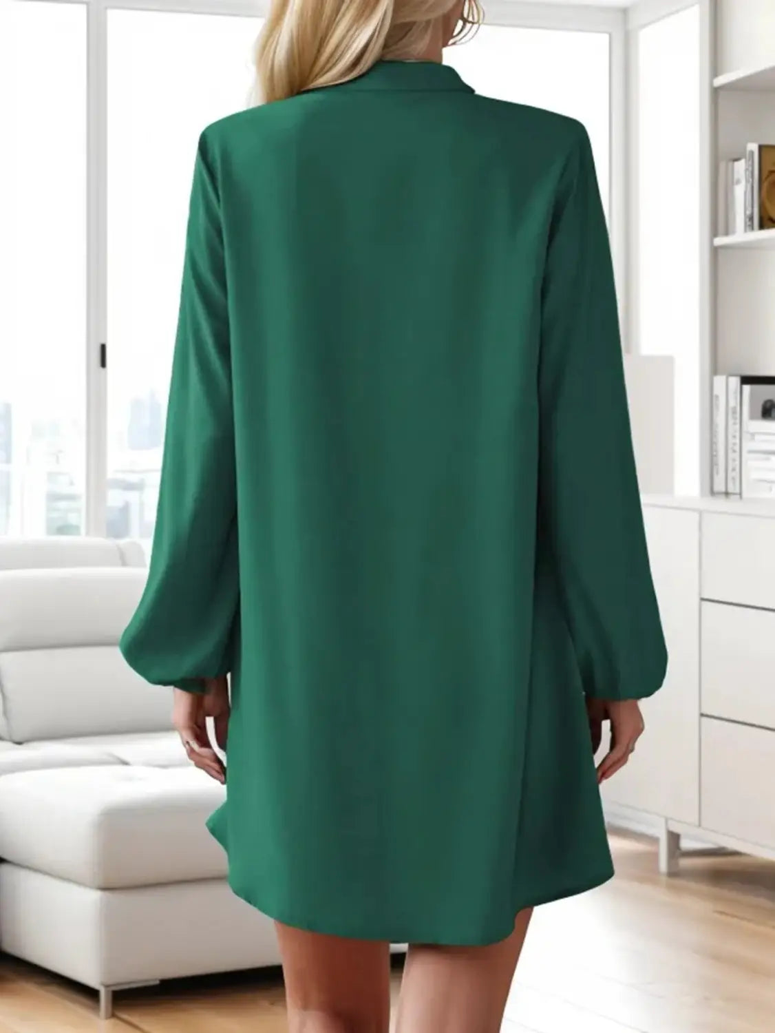 Emerald green satin blazer dress with long sleeves and a relaxed fit shown from the front in bell sleeve button down midi dress style.