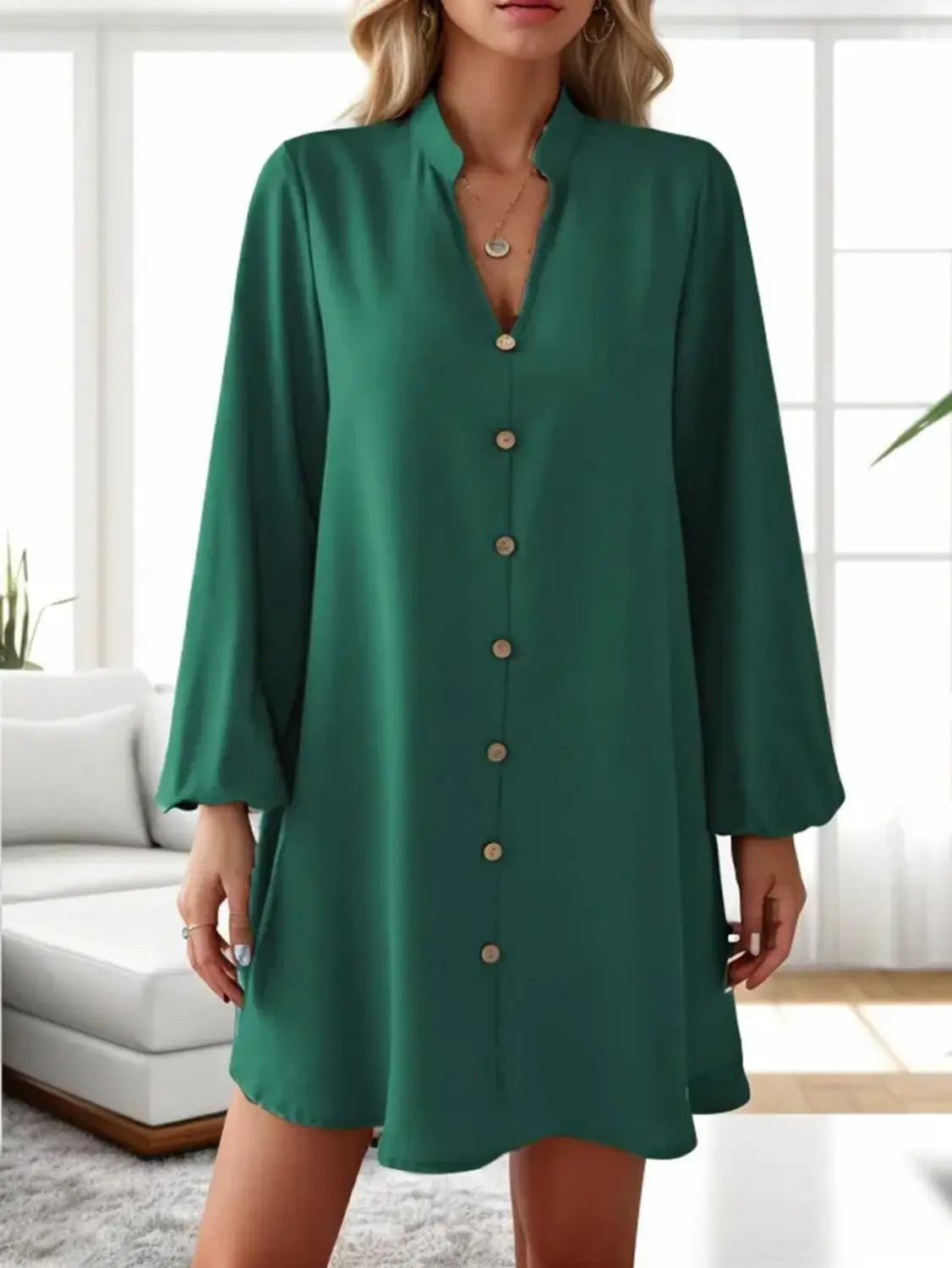 Emerald green bell sleeve button down midi dress with long sleeves, relaxed fit, and flared hem made from lightweight fabric for elegant casual wear.