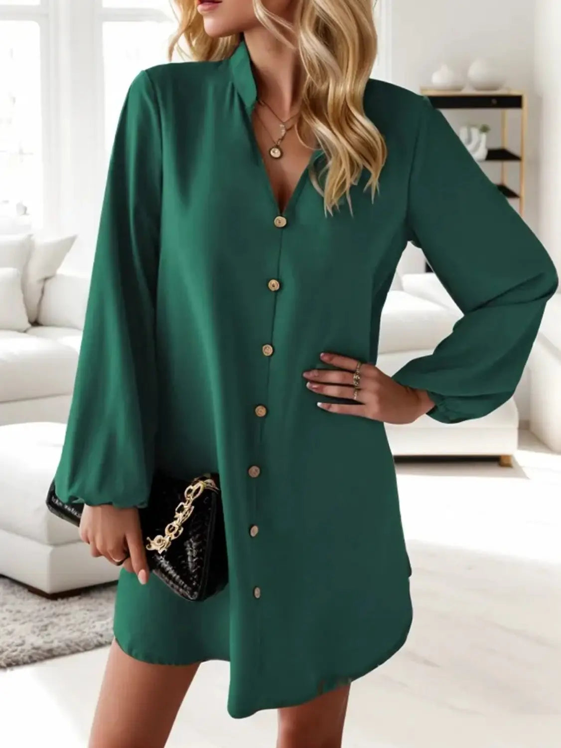 Emerald green bell sleeve button down midi dress with long sleeves and a v-neckline in a lightweight fabric.