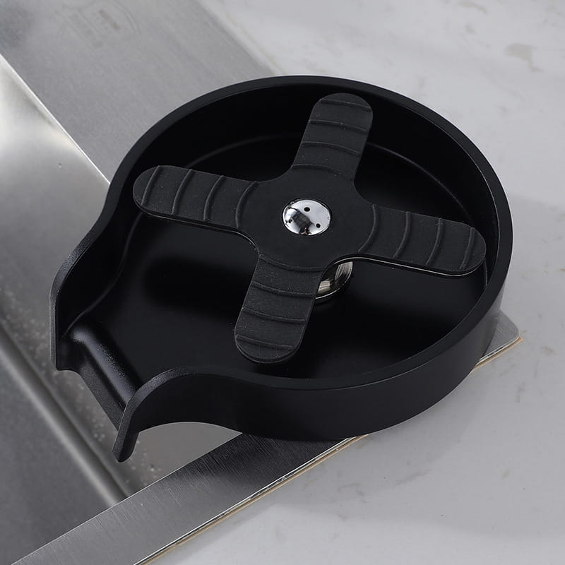 black plastic bar sink drain catcher with cross-shaped grip and metallic center bolt for cup washer in kitchen sink automatic glass rinser