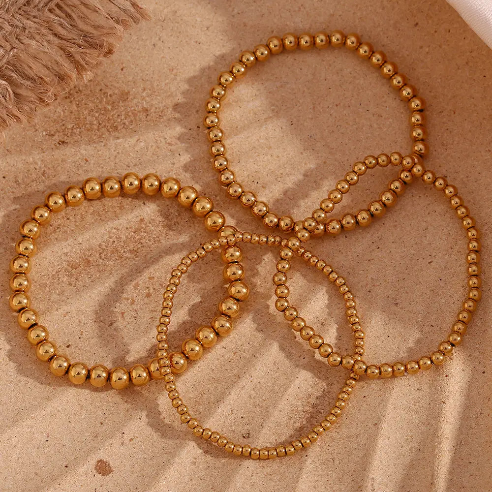 18k gold plated stainless steel elastic bead bracelet featuring golden beaded stretch design with a shiny metallic finish.