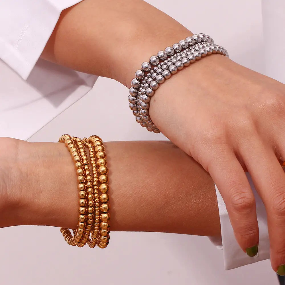 stacked 18k gold plated stainless steel elastic bead bracelets in gold and silver tones