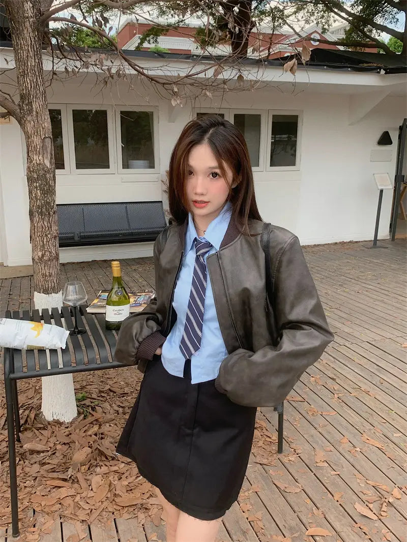 Brown faux leather bomber jacket in retro biker style displayed from the back side.