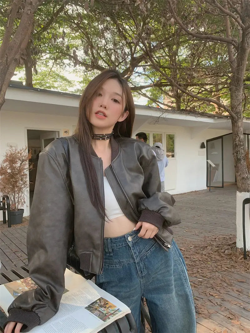 dark gray faux leather bomber jacket with ribbed cuffs and collar in retro biker style.
