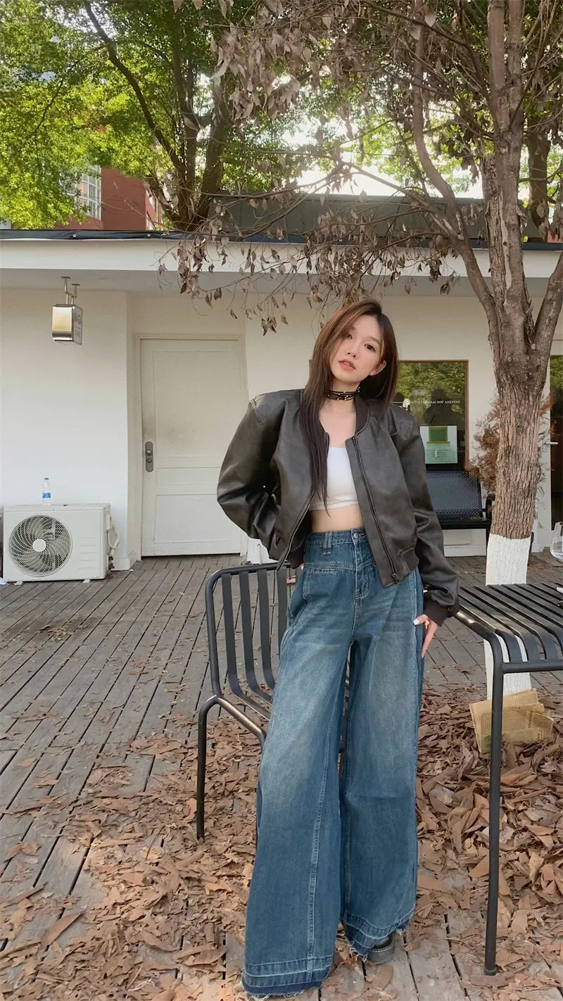 Black leather faux leather bomber jacket in retro biker style shown from the back side.