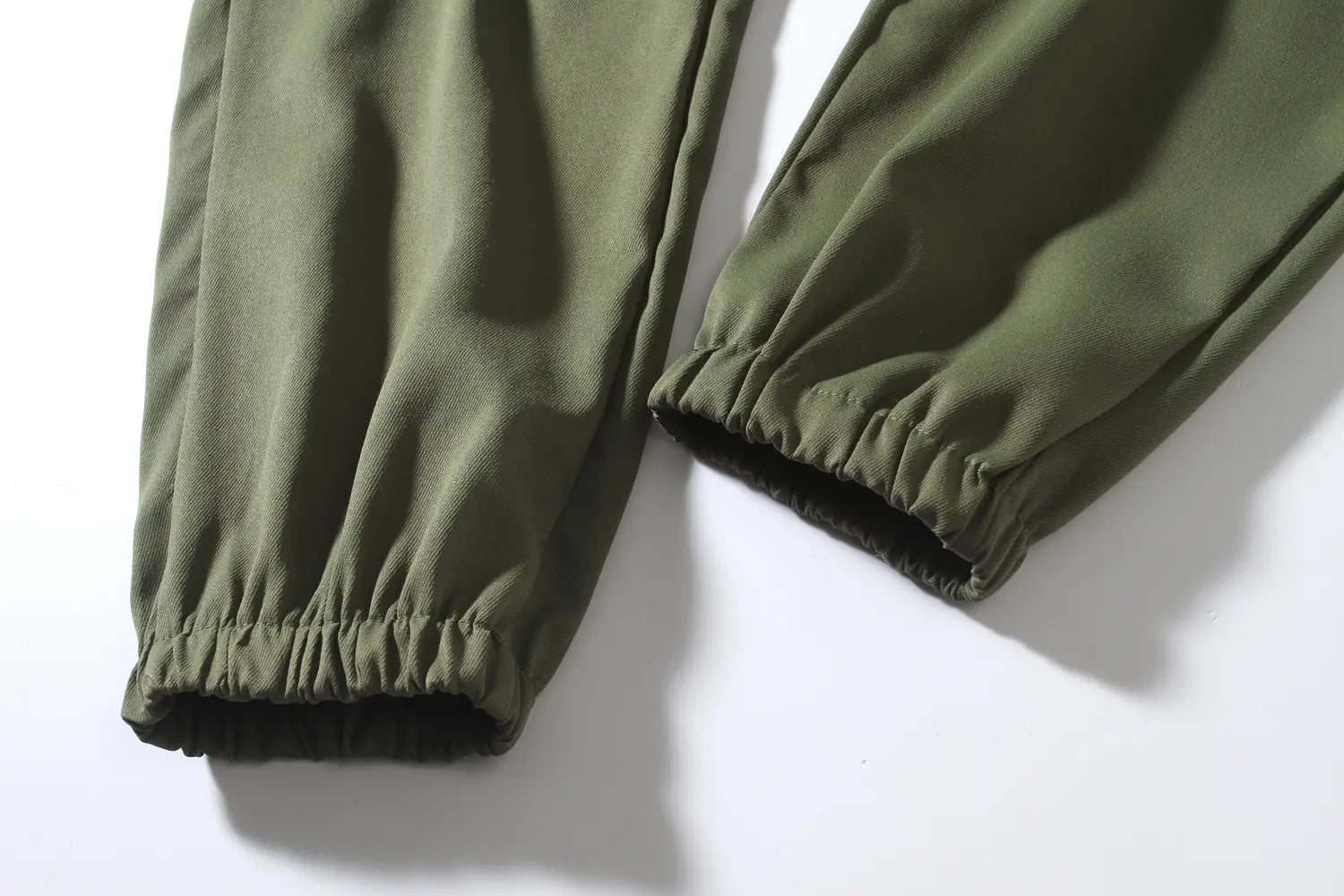 olive green mens multi pocket cargo work pants made of soft stretchy fabric featuring elastic cuffs for comfort.