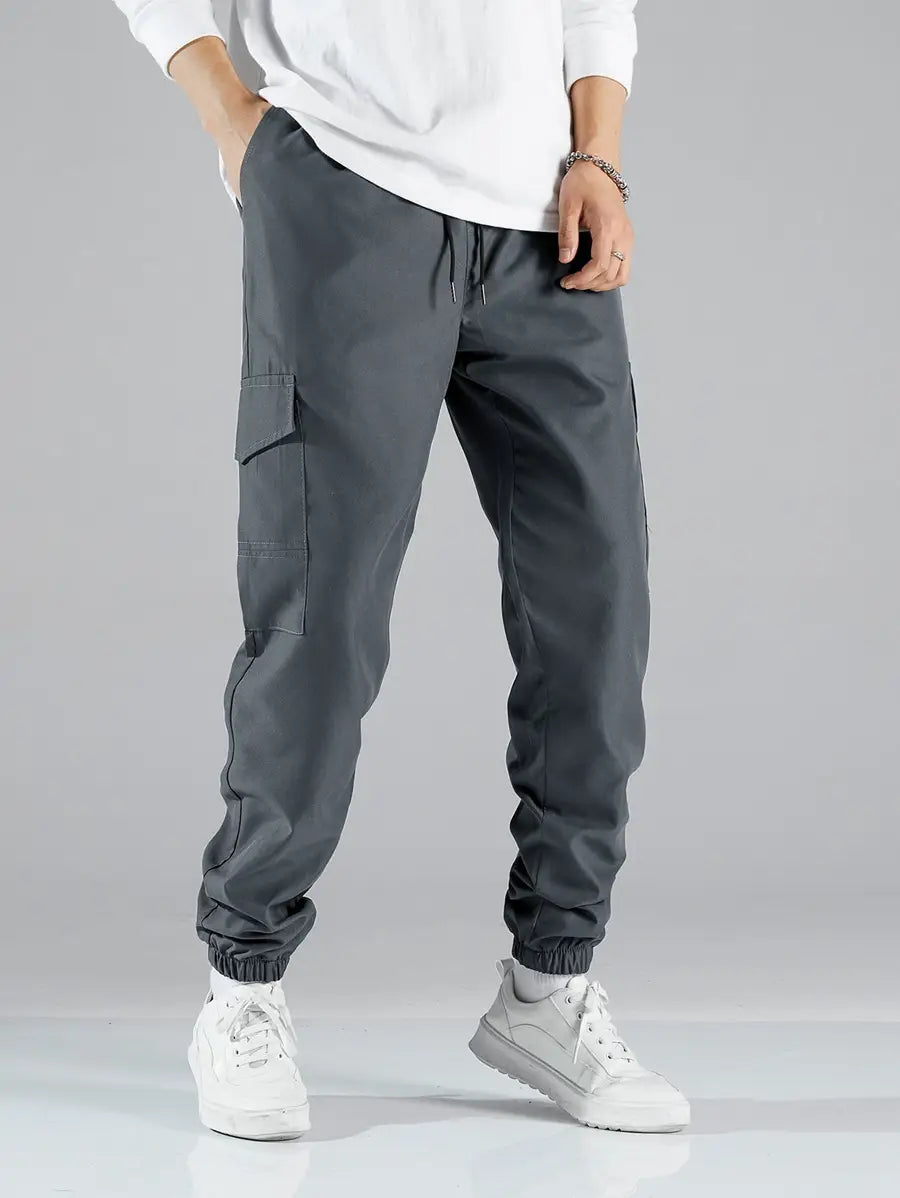 Dark gray mens multi pocket cargo work pants featuring multiple pockets and elastic cuffs for durability and comfort.