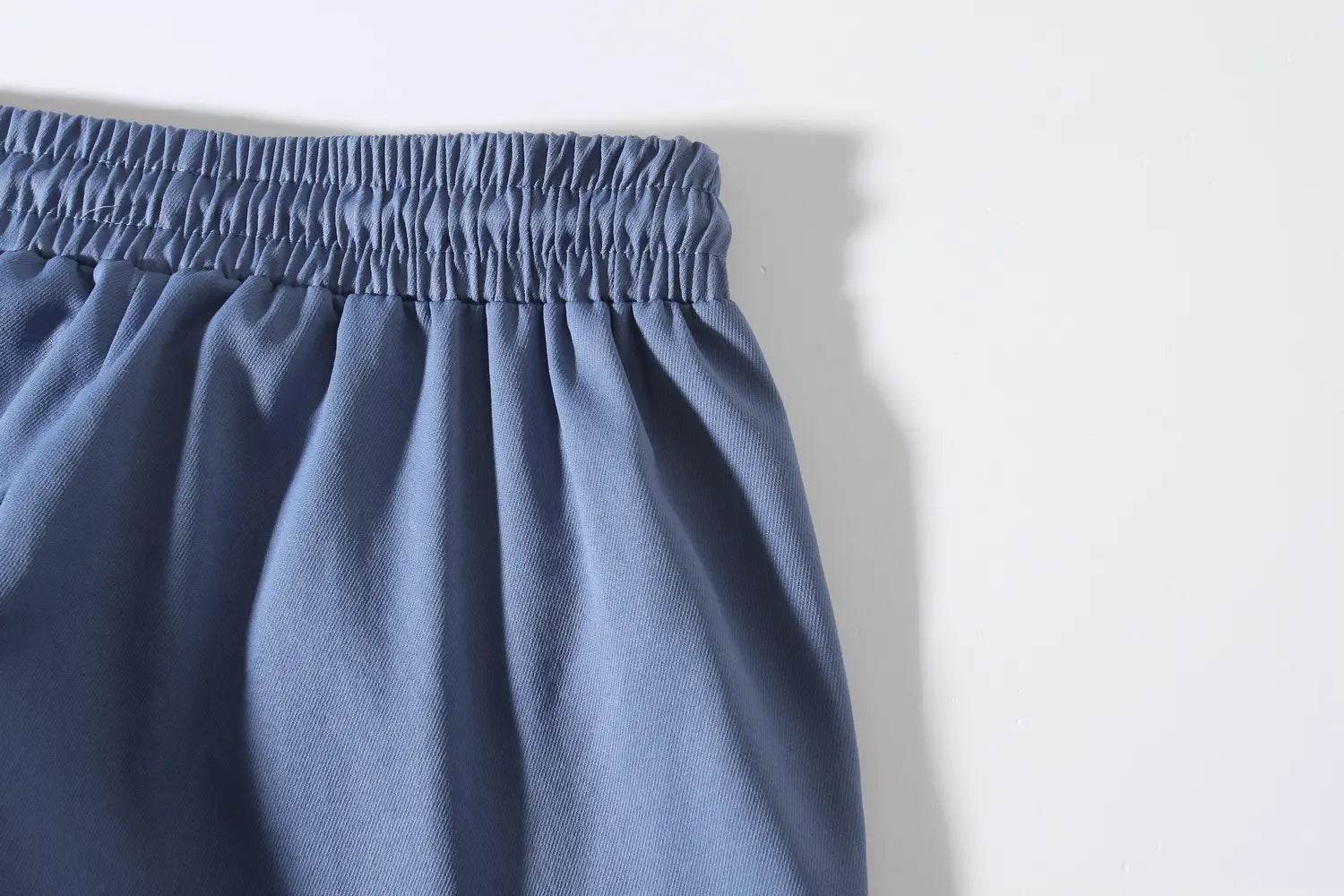 mens multi pocket cargo work pants made of blue denim with an elastic waistband for added comfort