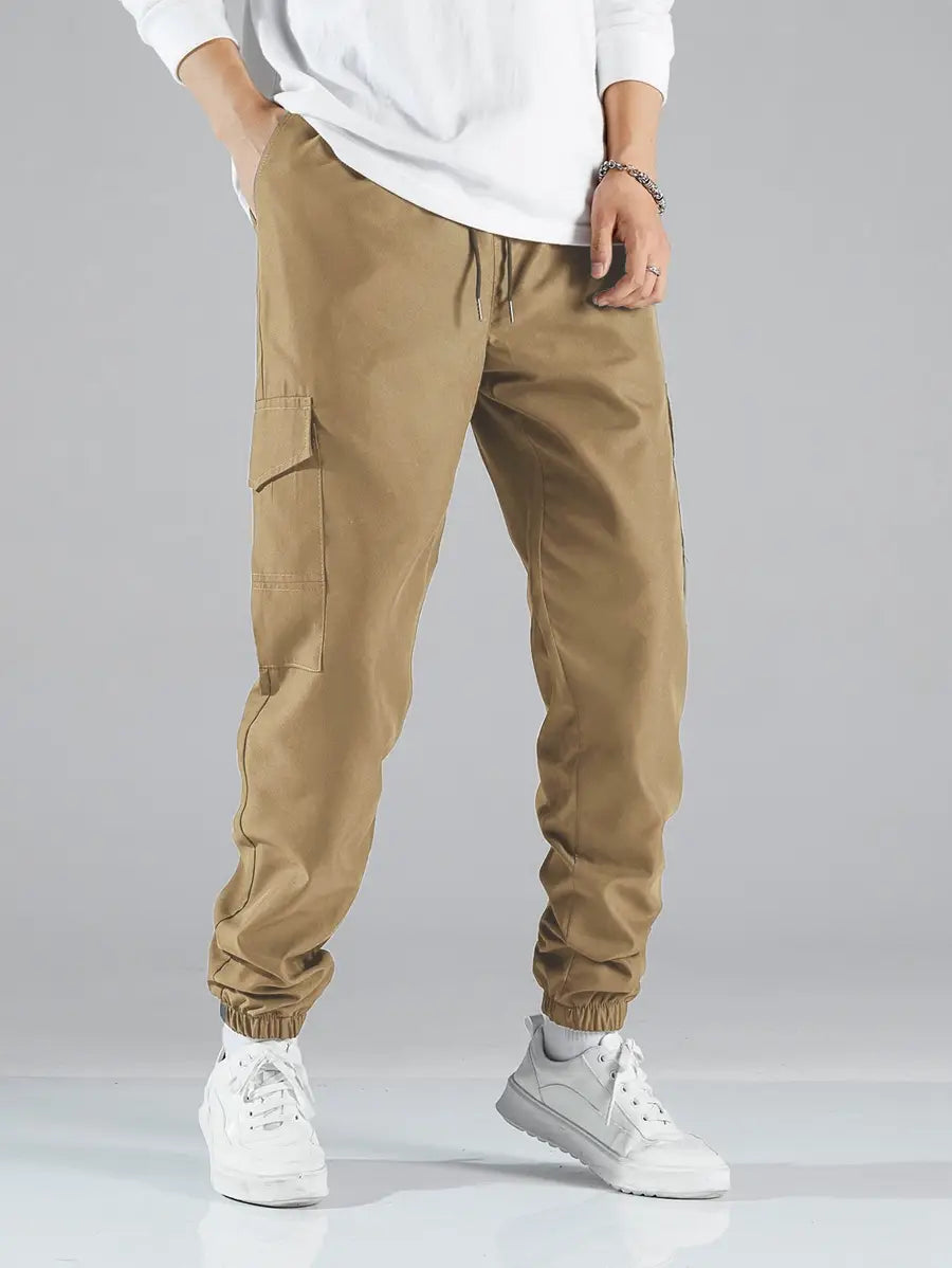 Mens multi pocket cargo work pants in tan with elastic cuffs and side pockets designed for durability and functionality.