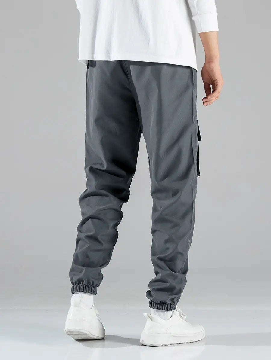 Mens multi pocket cargo work pants in dark gray with elastic cuffs and side pockets designed for durability and functionality.