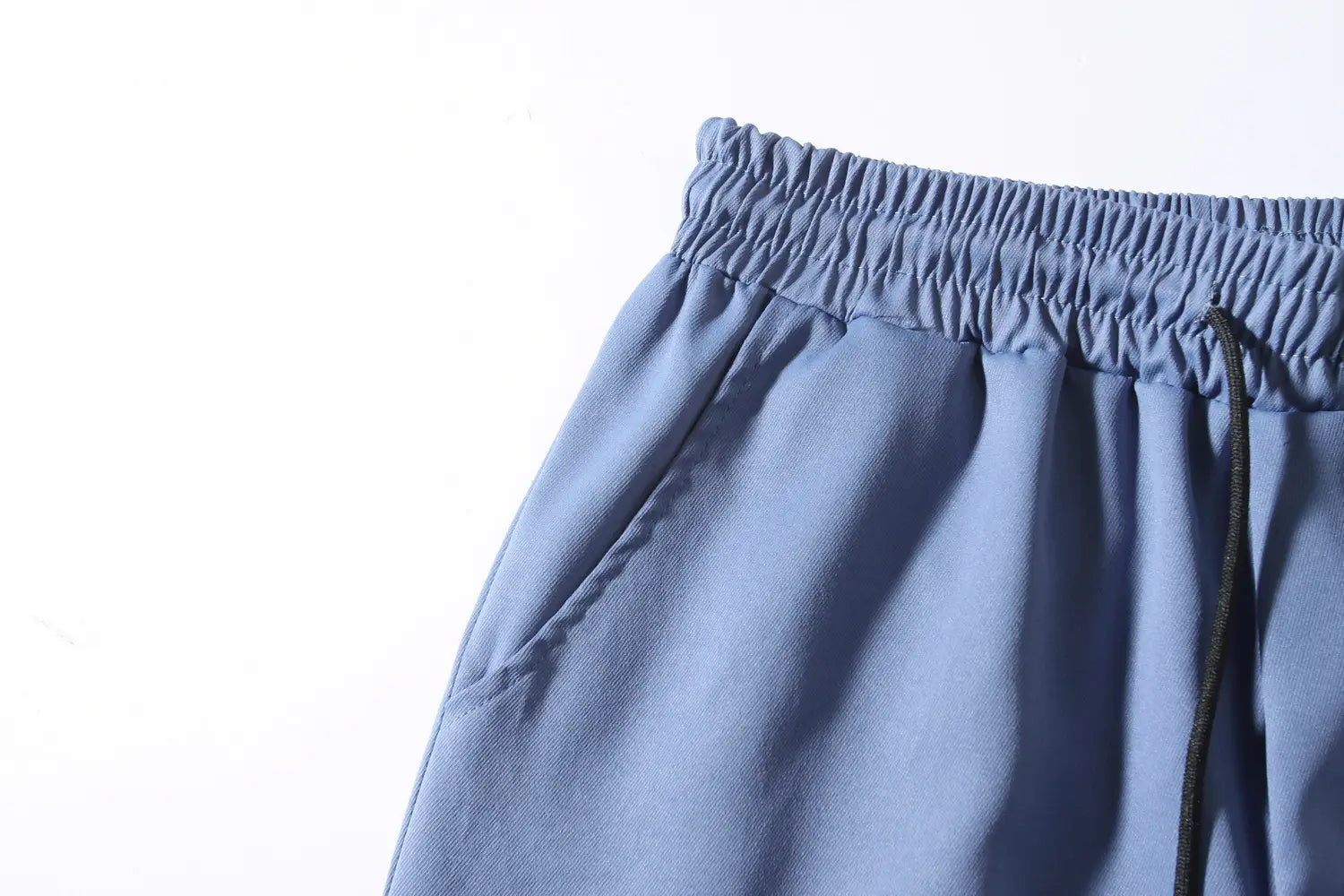 Mens multi pocket cargo work pants in blue with elastic waist and black drawstring designed for durability and comfort.