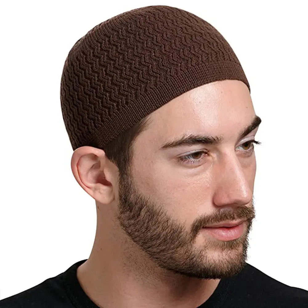 Brown knitted jacquard winter beanie hat featuring a textured herringbone pattern in a kufi cap style.