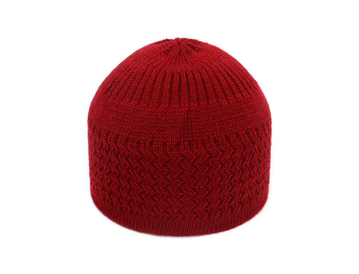 A vibrant red knitted jacquard winter beanie hat featuring a textured zigzag pattern and ribbed detailing.