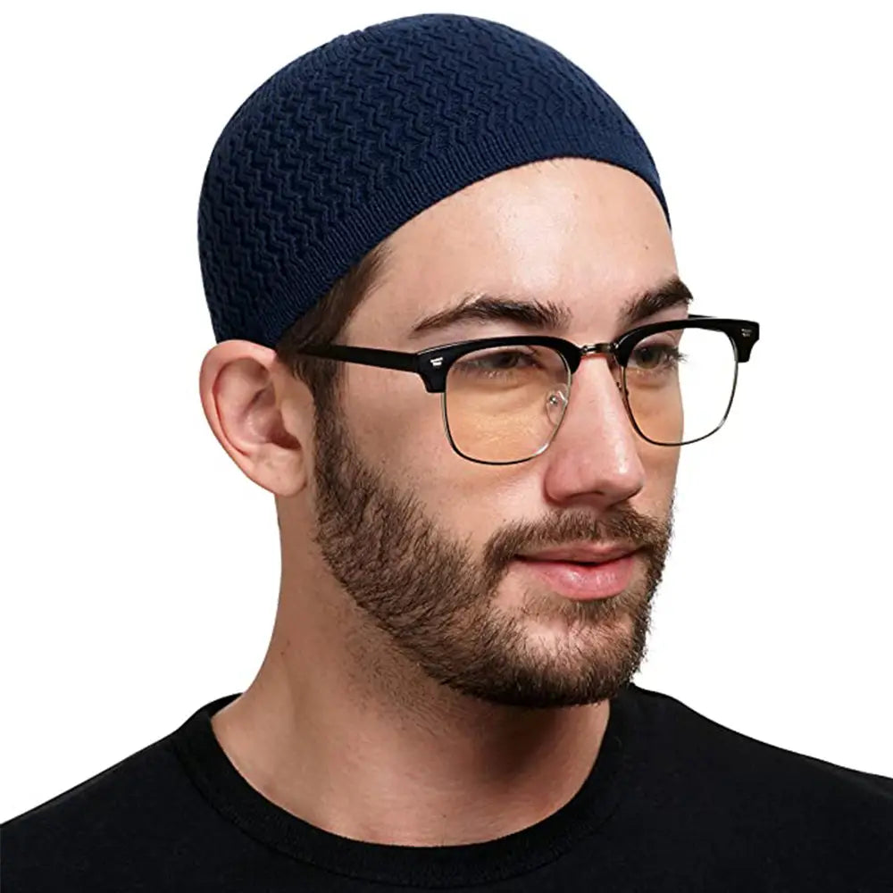 Navy blue knitted jacquard winter beanie hat with a herringbone pattern made from warm knit material.