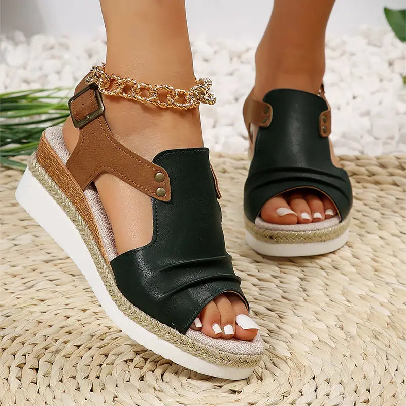 Wedge sandals for women with black and brown leather peep toe espadrille design and gold chain ankle strap ideal for beachwear.