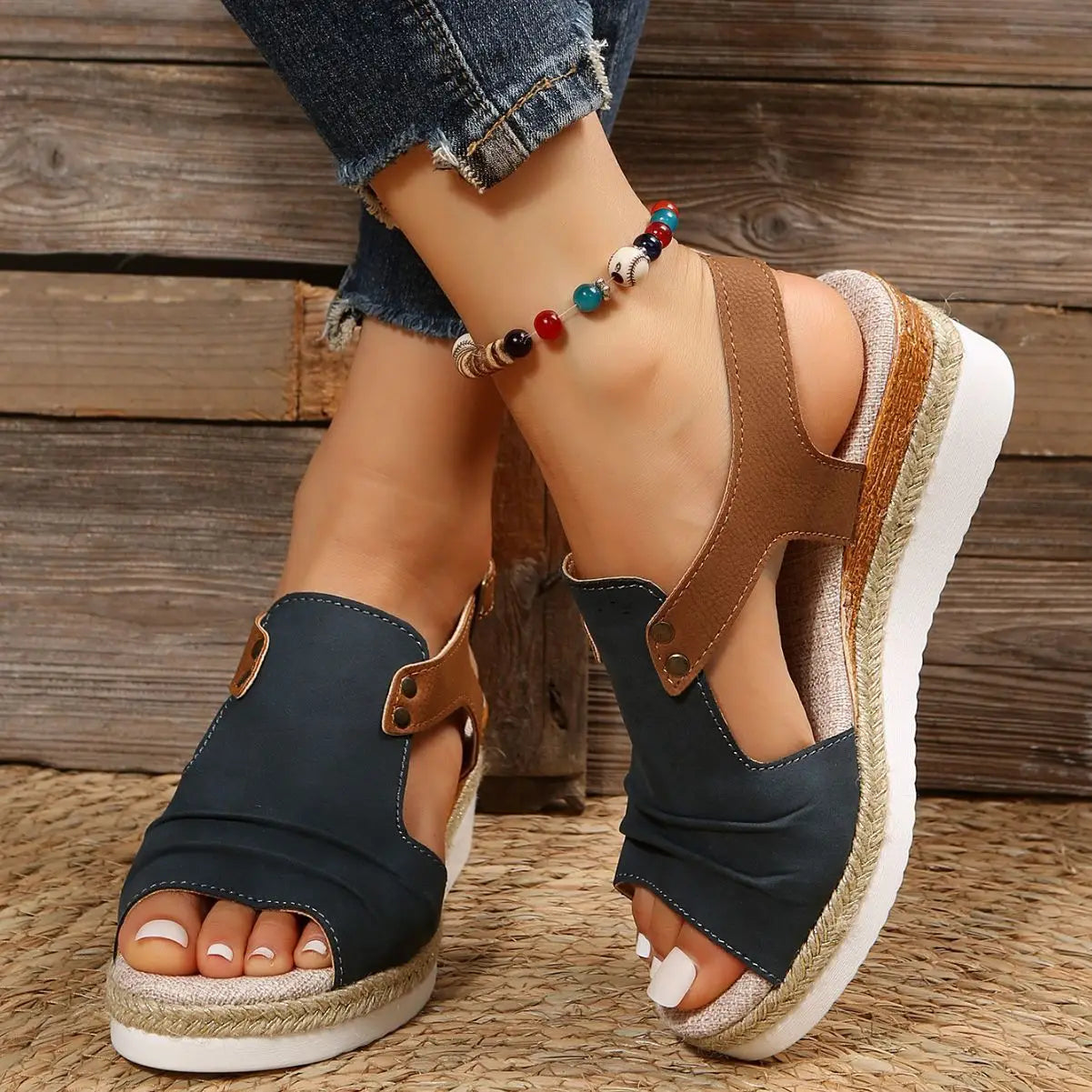 Dark blue and brown leather wedge sandals for women with peep toe and woven rope espadrille sole suitable for beachwear.