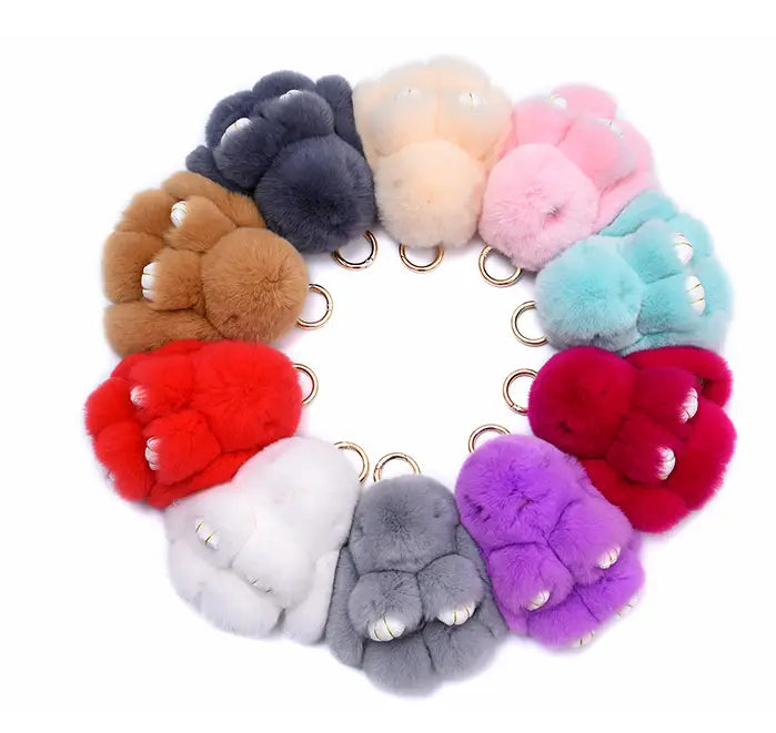 A collection of rabbit plush keychain soft fuzzy animal pendants in vibrant red pink blue and purple colors measuring 15cm.