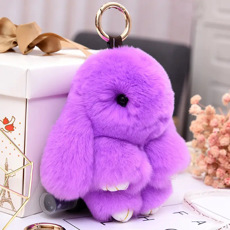 Purple plush rabbit keychain with soft fuzzy material black button eyes and white paw tips attached to a gold-colored metal ring measuring 15cm.