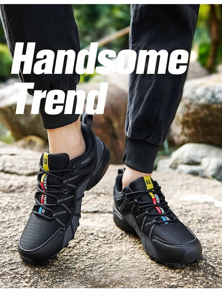 Men’s breathable mesh trail running and hiking shoes in black with vibrant yellow and blue accents on the laces and branding featuring a mesh upper for breathability.