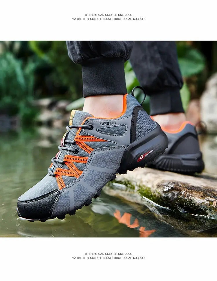 Men’s breathable mesh trail running and hiking shoe in gray and orange with a mesh upper, black rubber sole, and speed branding on the side.