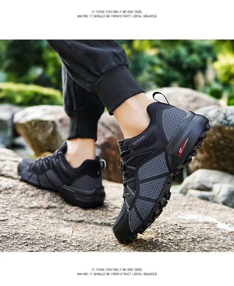 Men’s breathable black and gray mesh trail running and hiking shoe with a rugged outsole and red branding on the side.