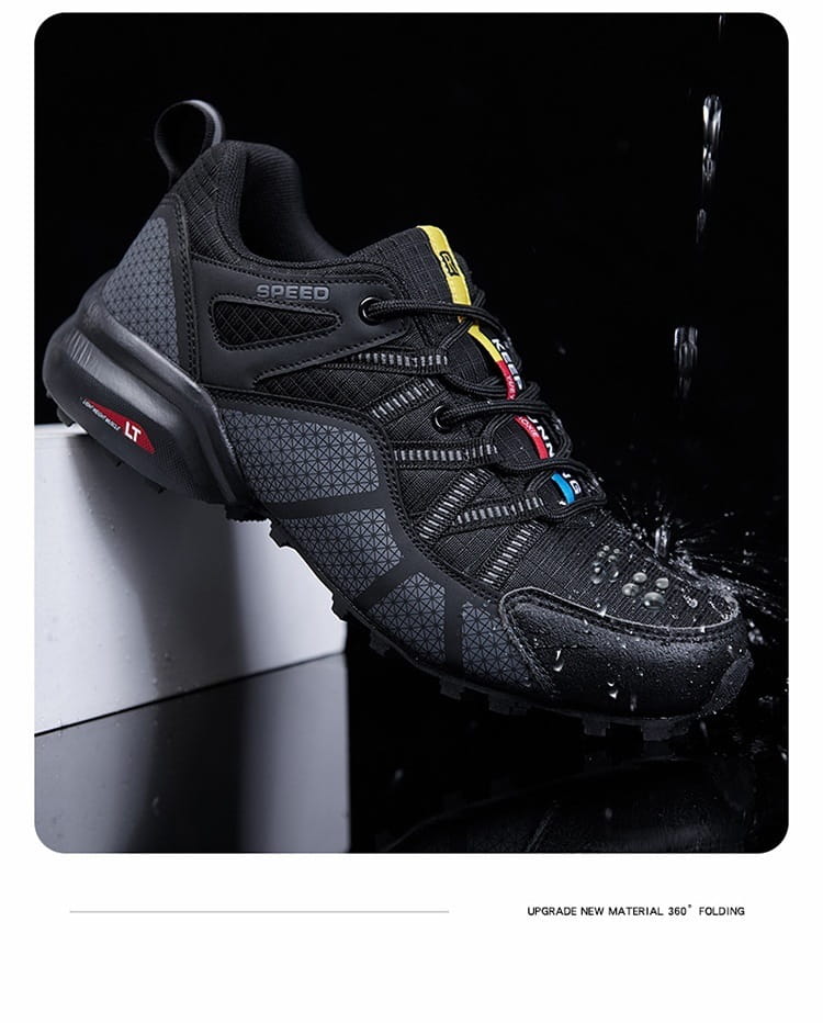 Black men’s breathable mesh trail running and hiking shoe with gray mesh panels, yellow and red accents on the laces and heel tab, featuring a rugged tread pattern.