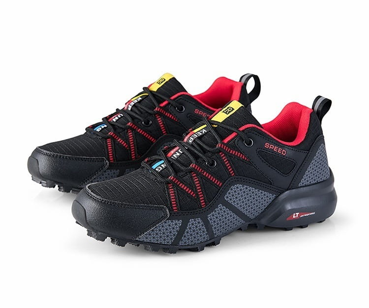 Men’s breathable mesh trail running and hiking shoes in black and red featuring a textured mesh upper, reinforced rubber outsole, and yellow branding accents.