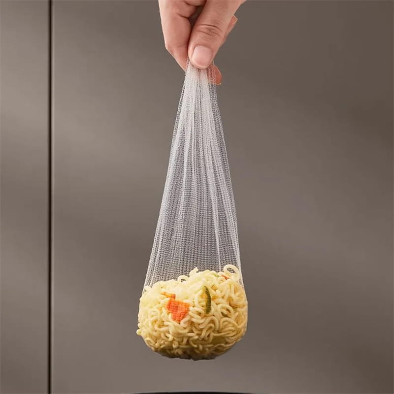 A clear fine-mesh metal noodle strainer from the kitchen sink filter rack with mesh strainer bags holding cooked instant noodles with visible vegetables.