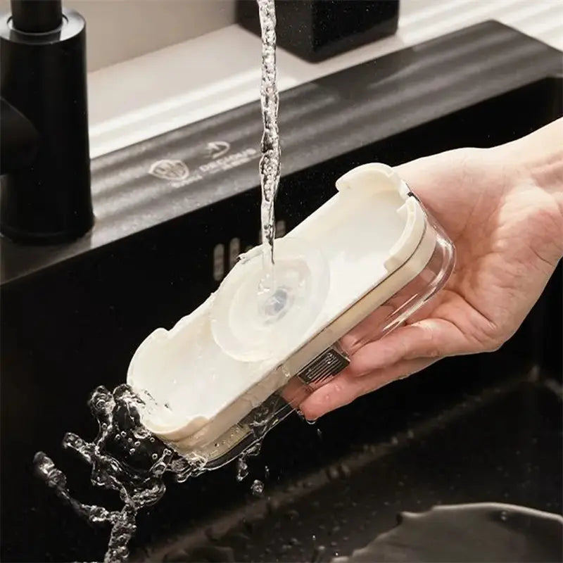 white and transparent plastic soap dispenser with suction cup base attached to a kitchen sink filter rack with mesh strainer bags
