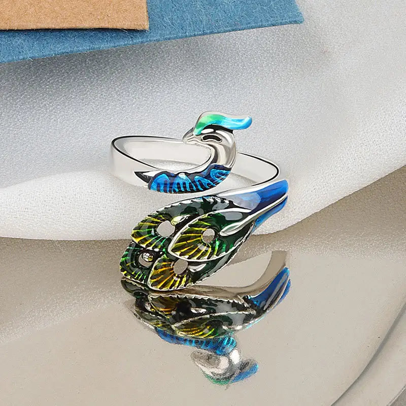 adjustable silver peacock ring with vibrant blue green and black enamel detailing on wings from peacock and fish crochet tension rings collection.