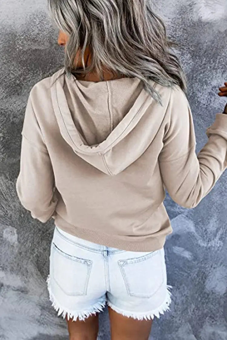 Beige women’s button neck drawstring hooded sweatshirt featuring a soft relaxed fit long-sleeved hoodie with ribbed cuffs.