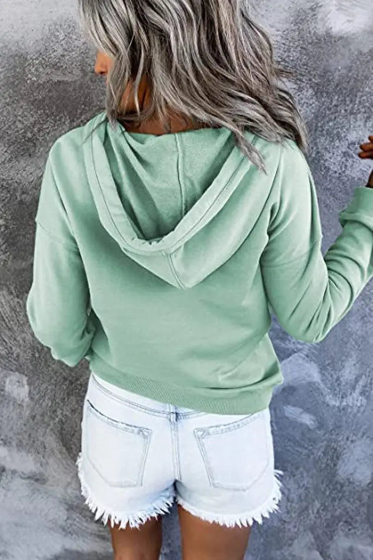 Women’s button neck drawstring hooded sweatshirt in soft mint green with long sleeves, relaxed fit, and ribbed cuffs.