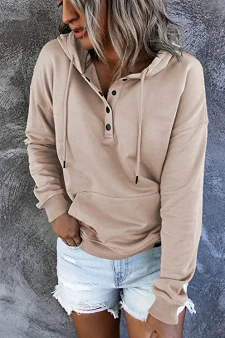Beige long-sleeved women’s button neck drawstring hooded sweatshirt with a buttoned placket and adjustable hood for casual wear.