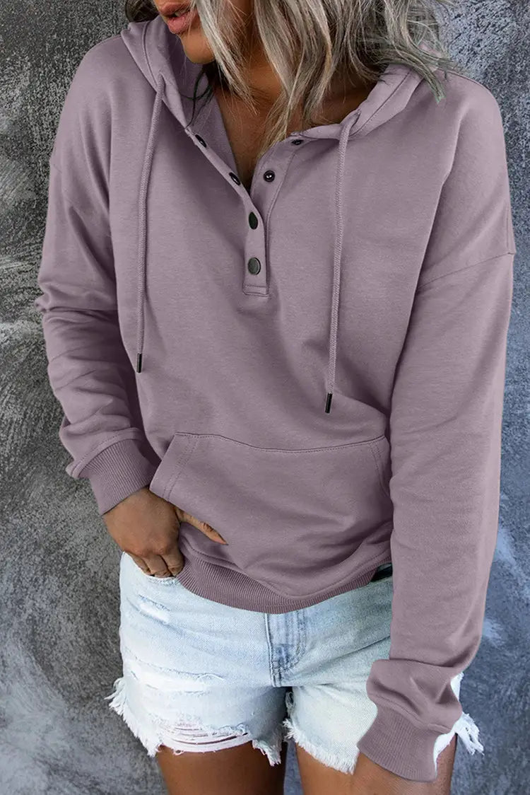 A soft lavender-colored long-sleeved women’s button neck drawstring hooded sweatshirt with a front button placket and drawstring hood.