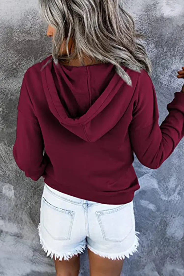 Women’s button neck drawstring hooded sweatshirt in maroon with long sleeves, soft cozy fabric, and relaxed fit.