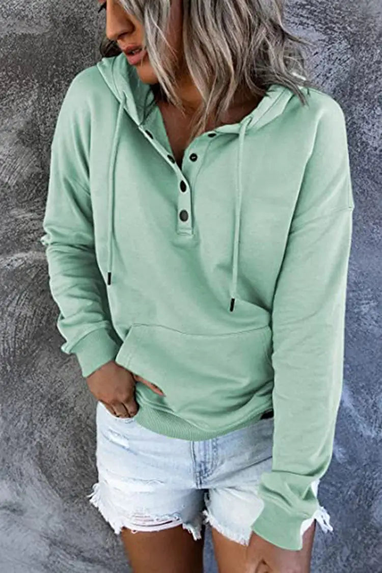 Women’s button neck drawstring hooded sweatshirt in mint green featuring long sleeves, black button accents, and adjustable drawstrings.