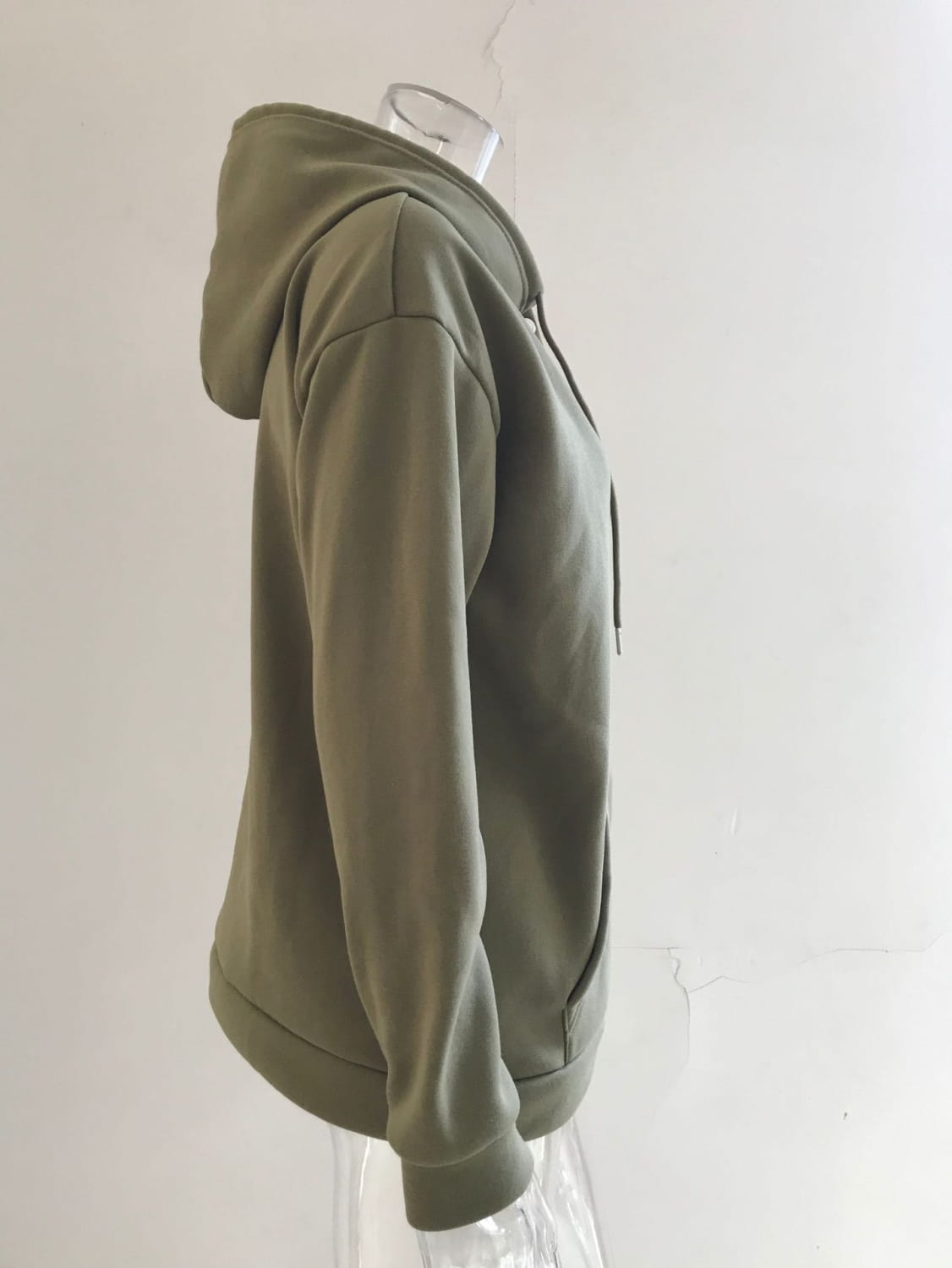 Olive green women’s button neck drawstring hooded sweatshirt made of soft textured fabric with matching drawstrings.