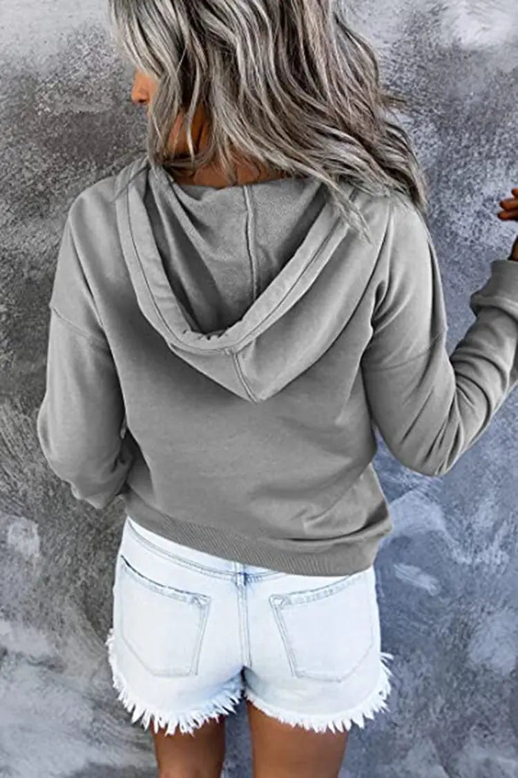A soft gray women’s button neck drawstring hooded sweatshirt with a relaxed fit and ribbed cuffs.