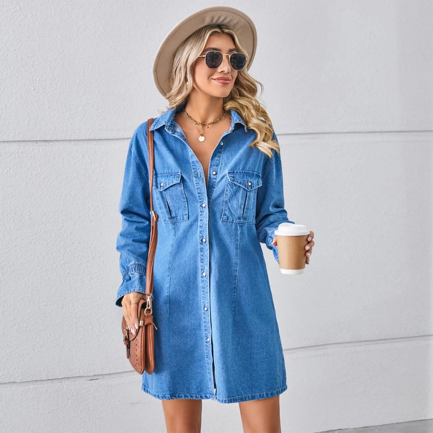 Blaues Jeansstoff-Kleid im A-Linien-Schnitt, mit weitem Langarm, Knopfleiste vorn und zwei Brusttaschen.