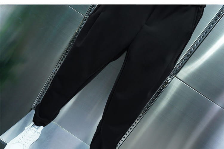 Men’s casual tapered jogger pants in black with a sleek tapered fit and subtle side stripes designed for comfortable everyday wear.