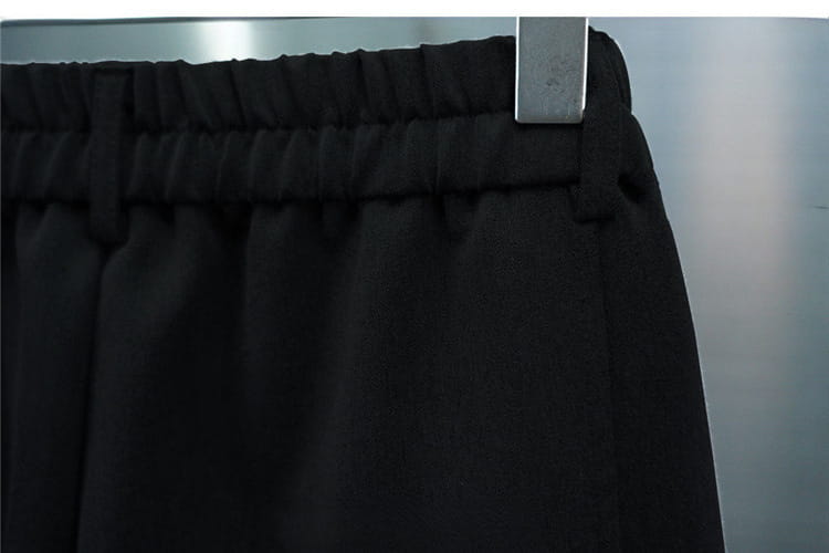 Men’s casual tapered jogger pants in black with elastic waist and smooth matte fabric finish.