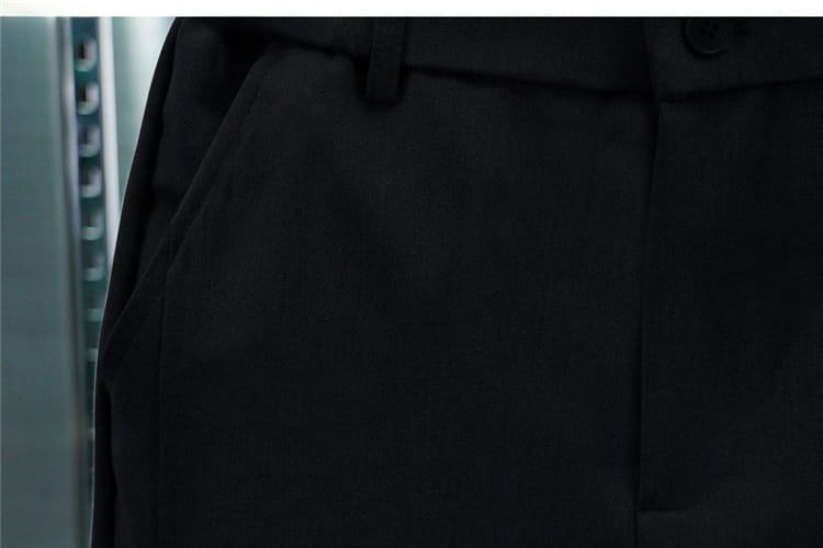 Men’s casual tapered jogger pants in black tailored trousers with smooth structured fabric and visible seam stitching.