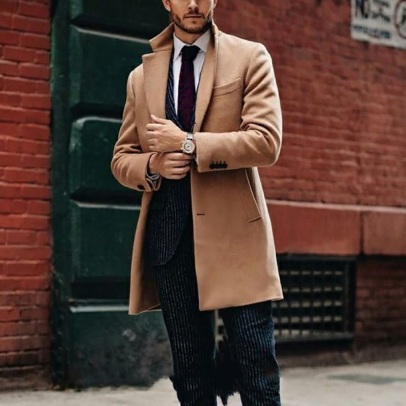 A stylish camel-colored mens double sided woolen overcoat featuring a classic notched lapel and two front pockets.