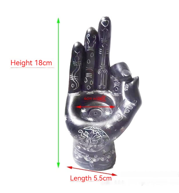 Black hamsa hand incense burner and candle holder figurine with intricate white etched patterns and a central circular design on the palm.