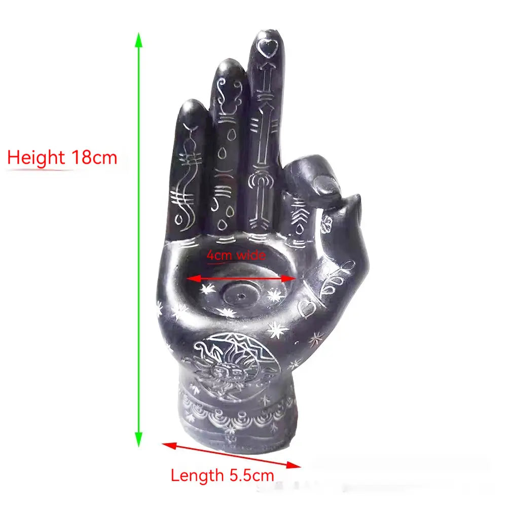 Black hand-shaped hamsa hand incense burner and candle holder figurine featuring intricate white etched patterns and a central circular design on the palm.