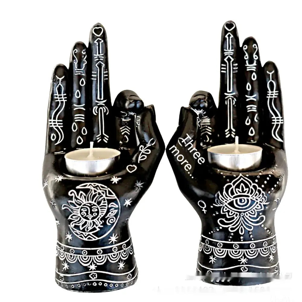 Black ceramic hamsa hand incense burner and candle holder figurines with intricate white tribal and symbolic designs each holding a small tealight candle.