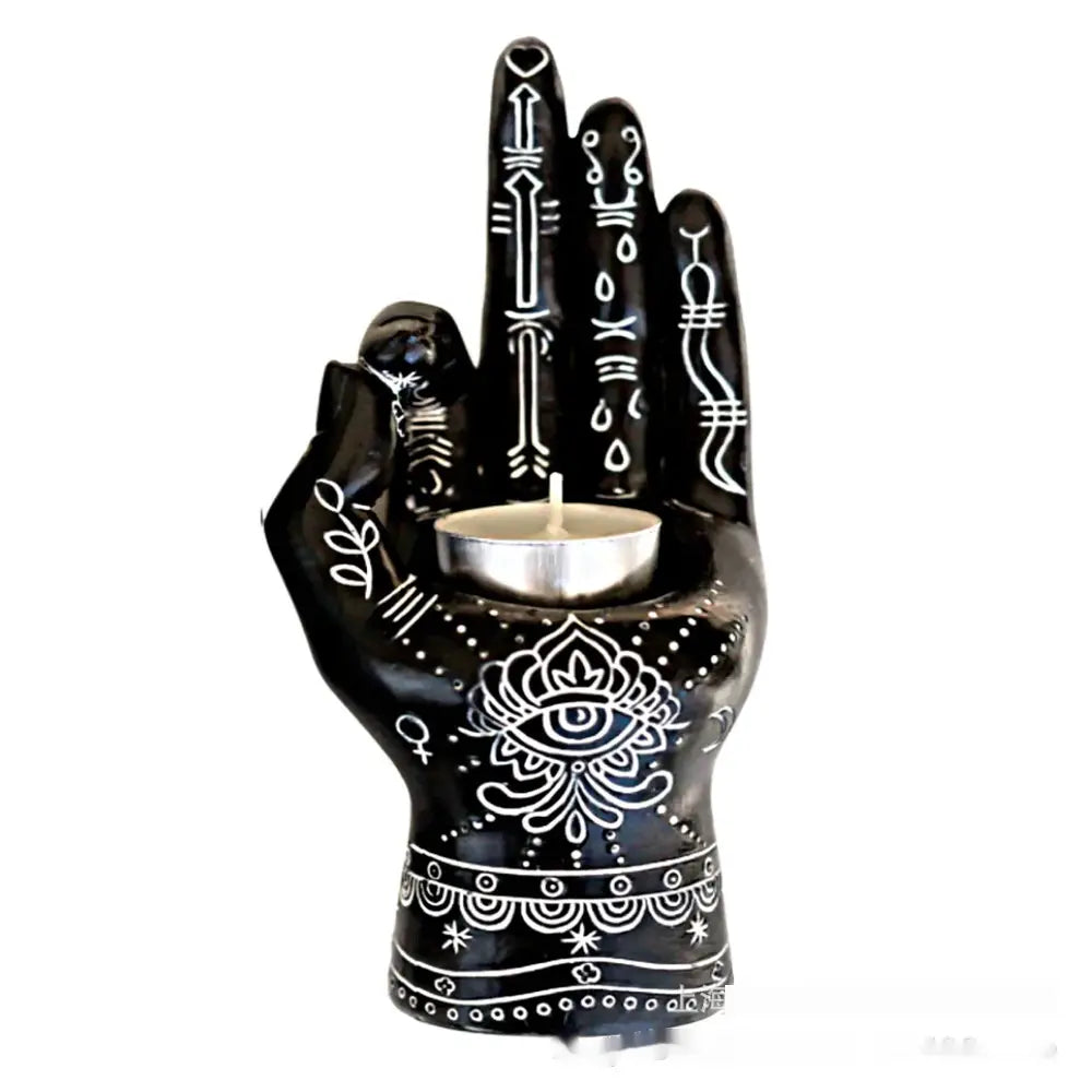 Black ceramic hamsa hand incense burner and candle holder figurine featuring intricate white henna-style patterns and a central eye motif.
