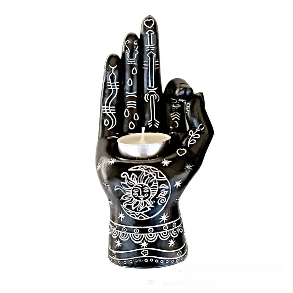Black ceramic hamsa hand incense burner and candle holder figurine with intricate white symbolic designs and a sun and moon motif on the palm.