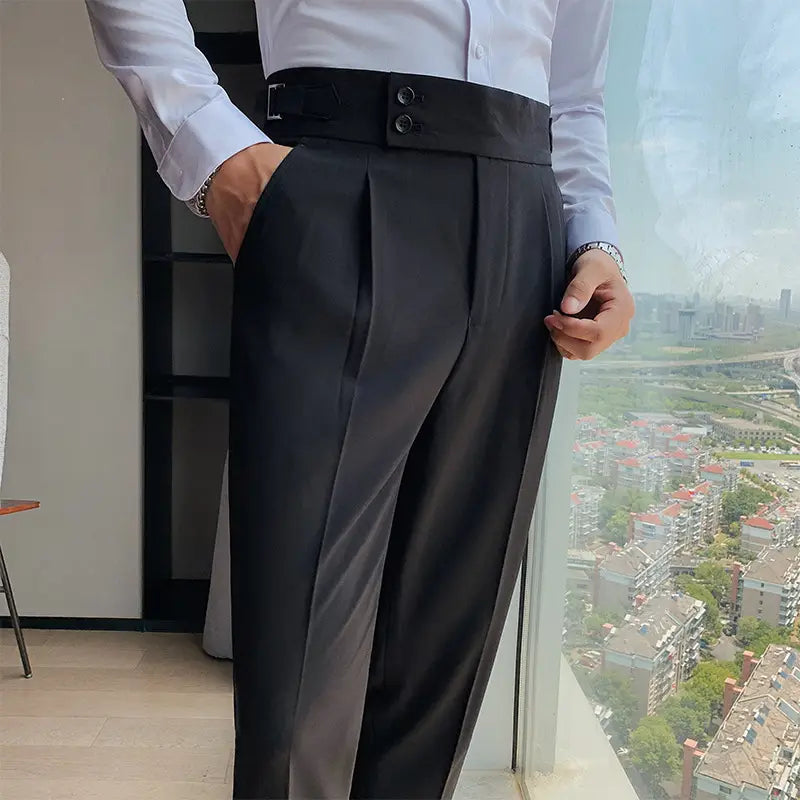 Men slim solid color black high-waisted pleated trousers with a wide belt and double-button closure made of lightweight fabric.